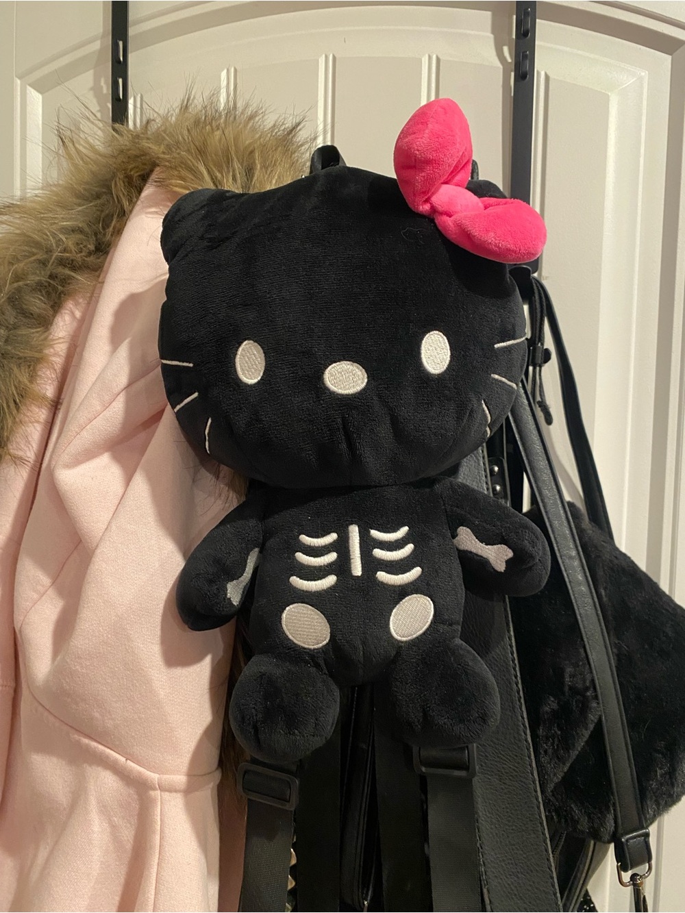 Dolls Kill Black Skeleton Kitty Plush Backpack with Hot Pink Bow